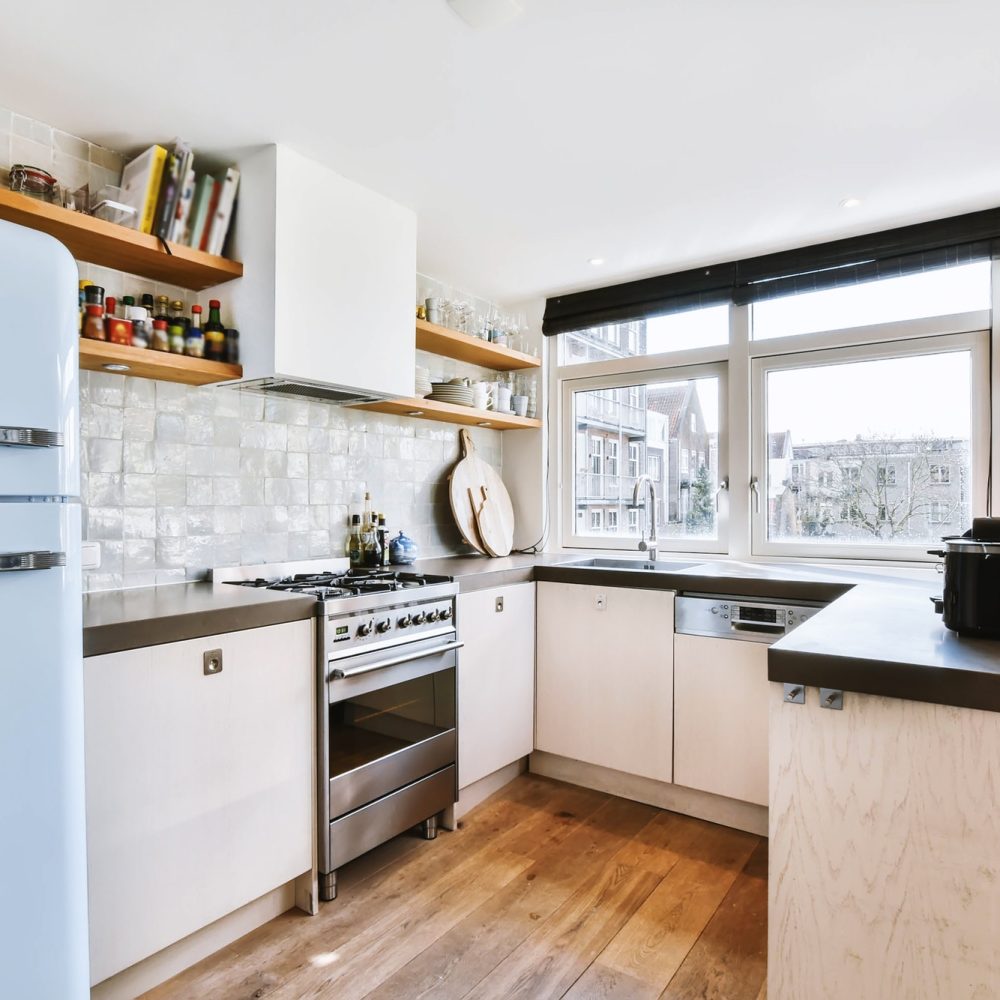 Interior of modern home kitchen with furniture and appliances