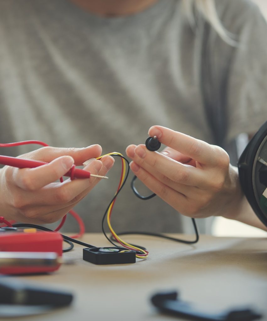 woman repairing electrical appliance at home